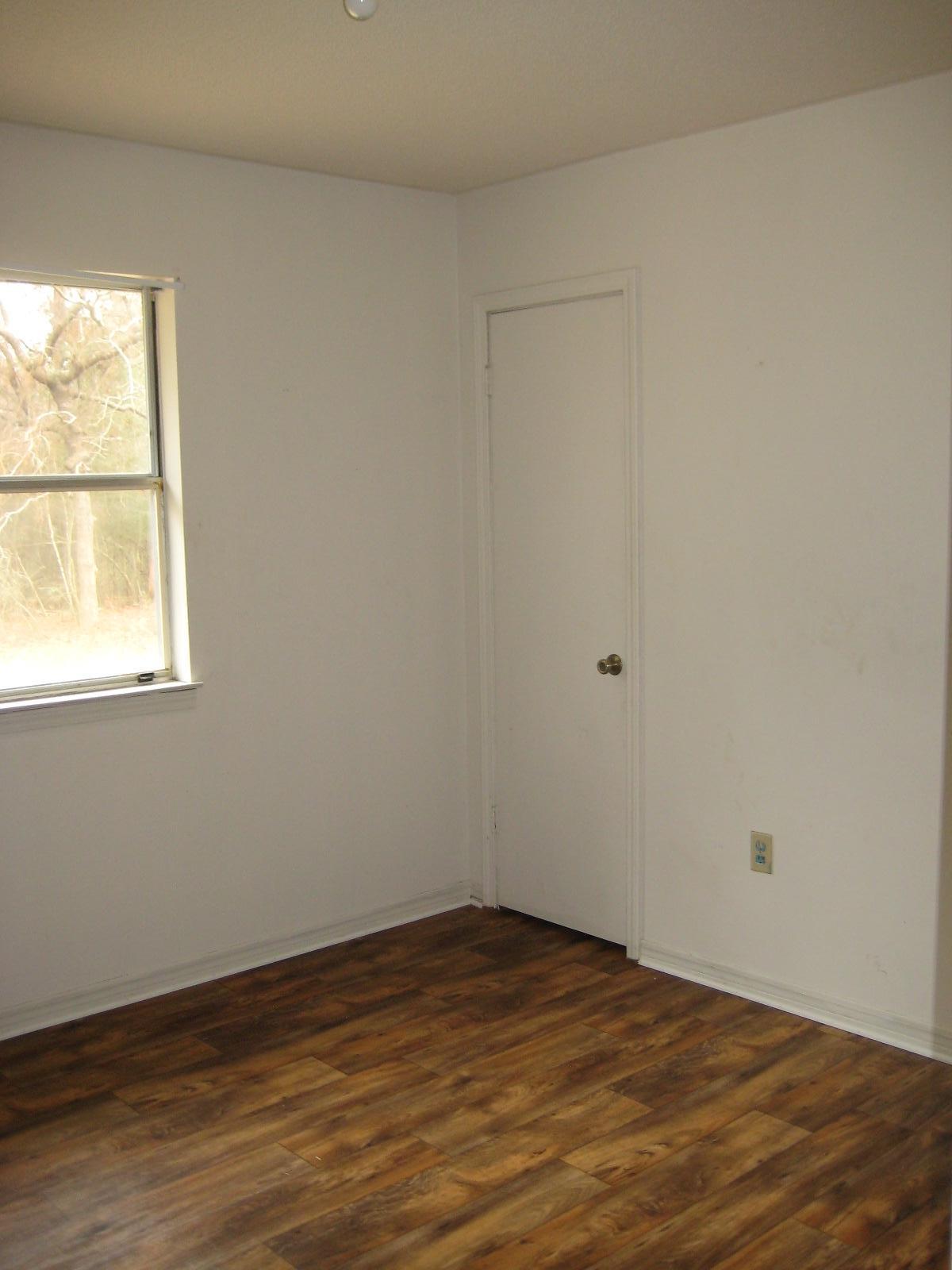 6003 Robin Road Crestview, FL 32539 - Photo 6 of 17 a view of empty room with wooden floor and fan