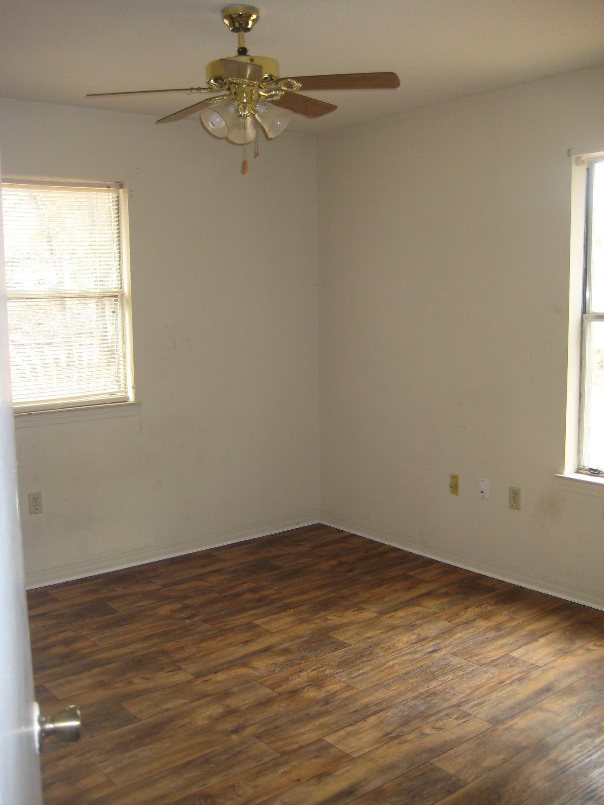 6003 Robin Road Crestview, FL 32539 - Photo 7 of 17 wooden floor in an empty room with a window