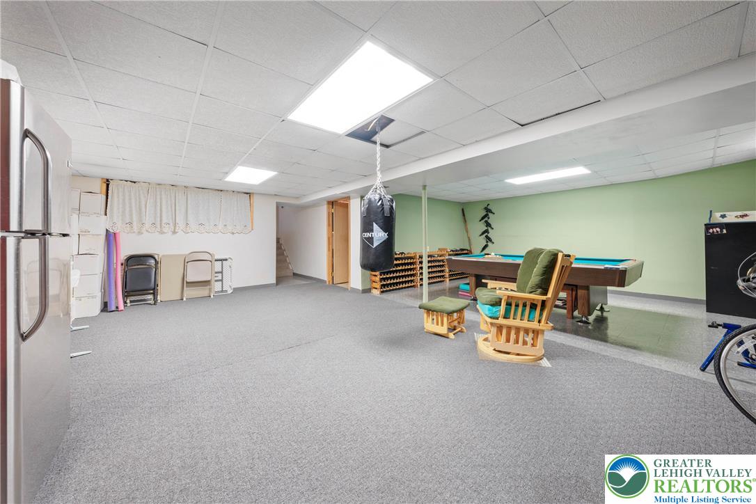 947 Tamenend Road Bath, PA 18014 - Photo 32 of 61 An adaptable recreation room with plush carpet, ideal for diverse activities and casual gatherings.