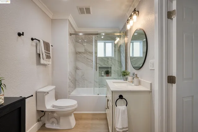 a bathroom with a toilet a sink and a mirror
