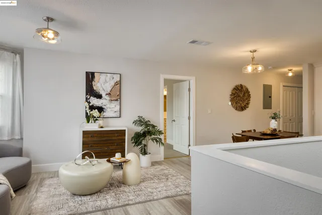 a living room with furniture and a mirror