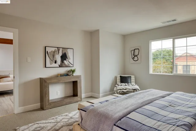 a bedroom with a bed and a fireplace