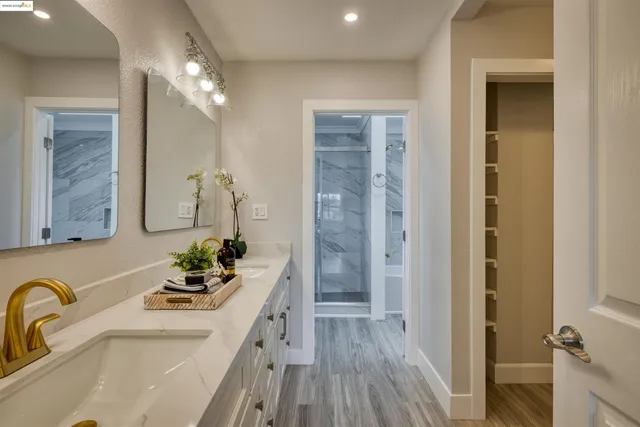a bathroom with a sink mirror and vanity