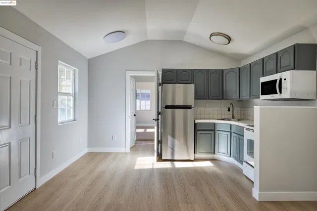 a kitchen with a refrigerator sink and microwave