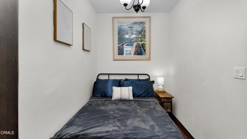 128 Lime Avenue, Unit 14 Long Beach, CA 90802 - Photo 14 of 31 a room with painting on the wall and a wooden floor