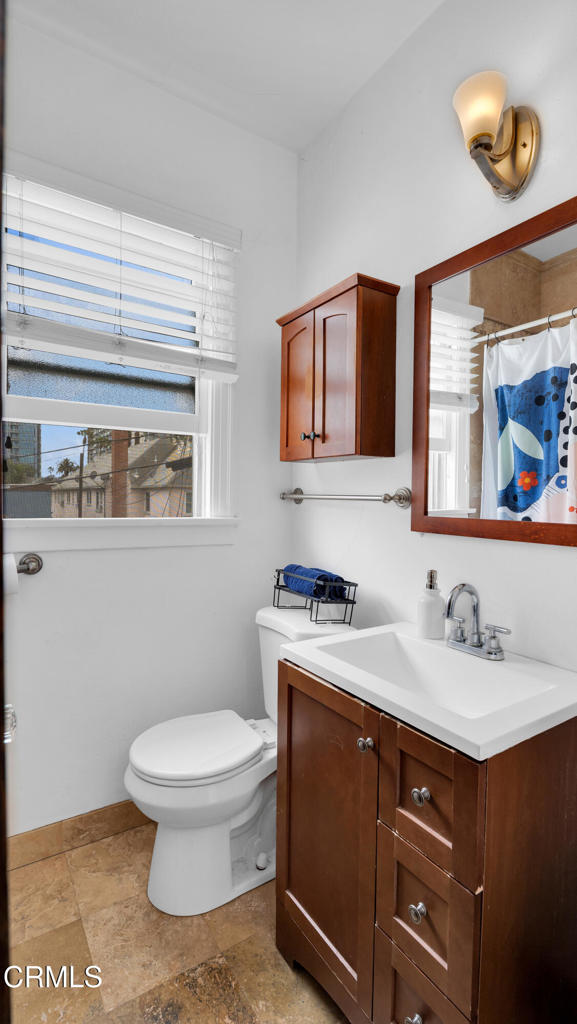 128 Lime Avenue, Unit 14 Long Beach, CA 90802 - Photo 17 of 31 a bathroom with a toilet a sink and mirror