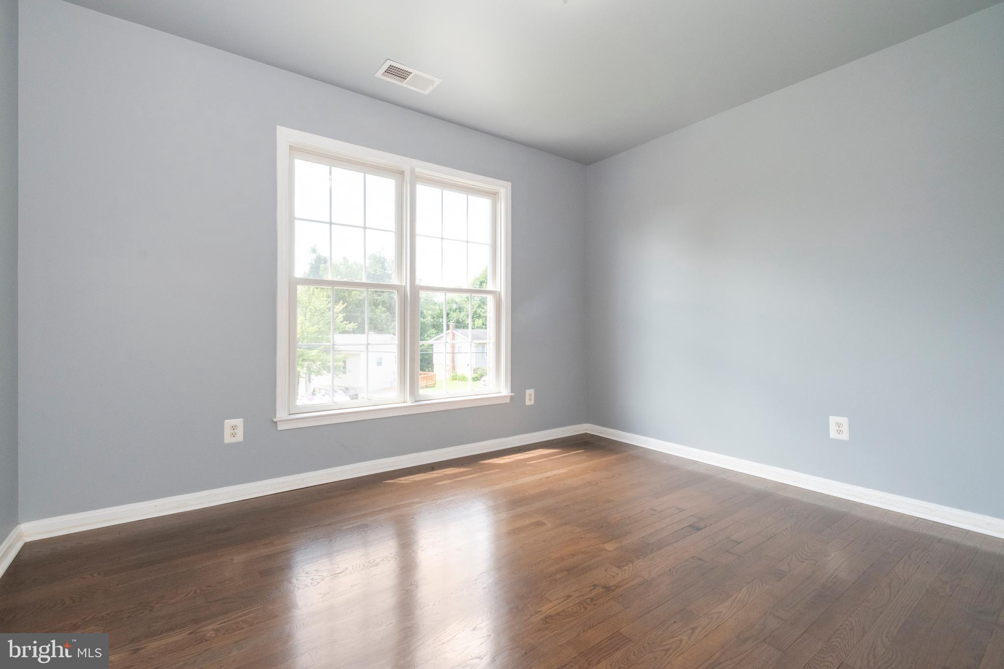 15 Johnson Road Pasadena, MD 21122 - Photo 32 of 40 an empty room with wooden floor and windows