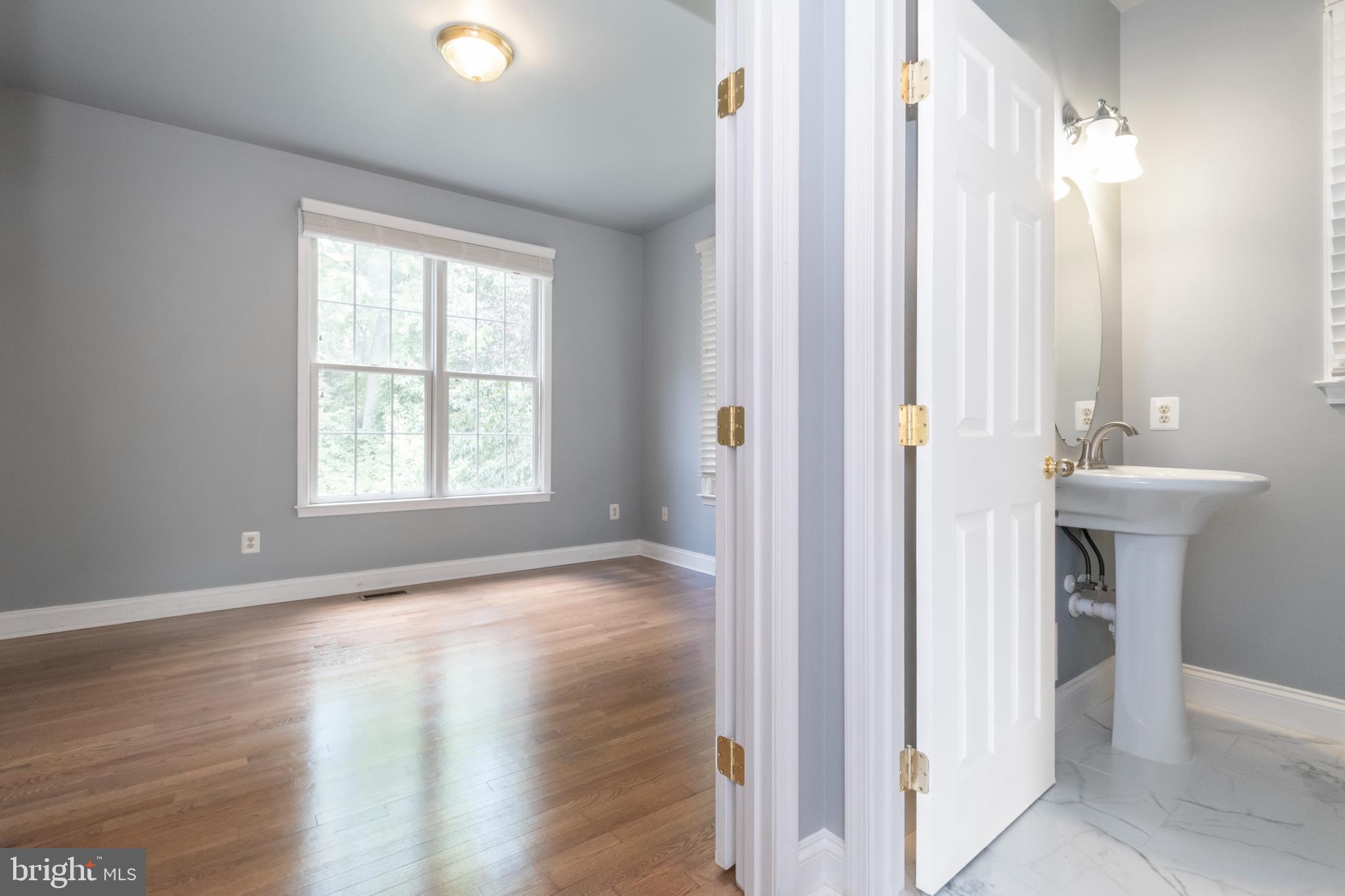 15 Johnson Road Pasadena, MD 21122 - Photo 10 of 40 a view of a hallway with wooden floor and a bathroom