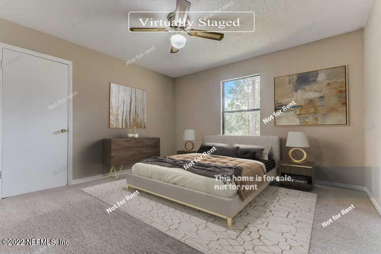 12348 Old Plank Road Jacksonville, FL 32220 - Photo 3 of 25 a bedroom with a bed and a chandelier