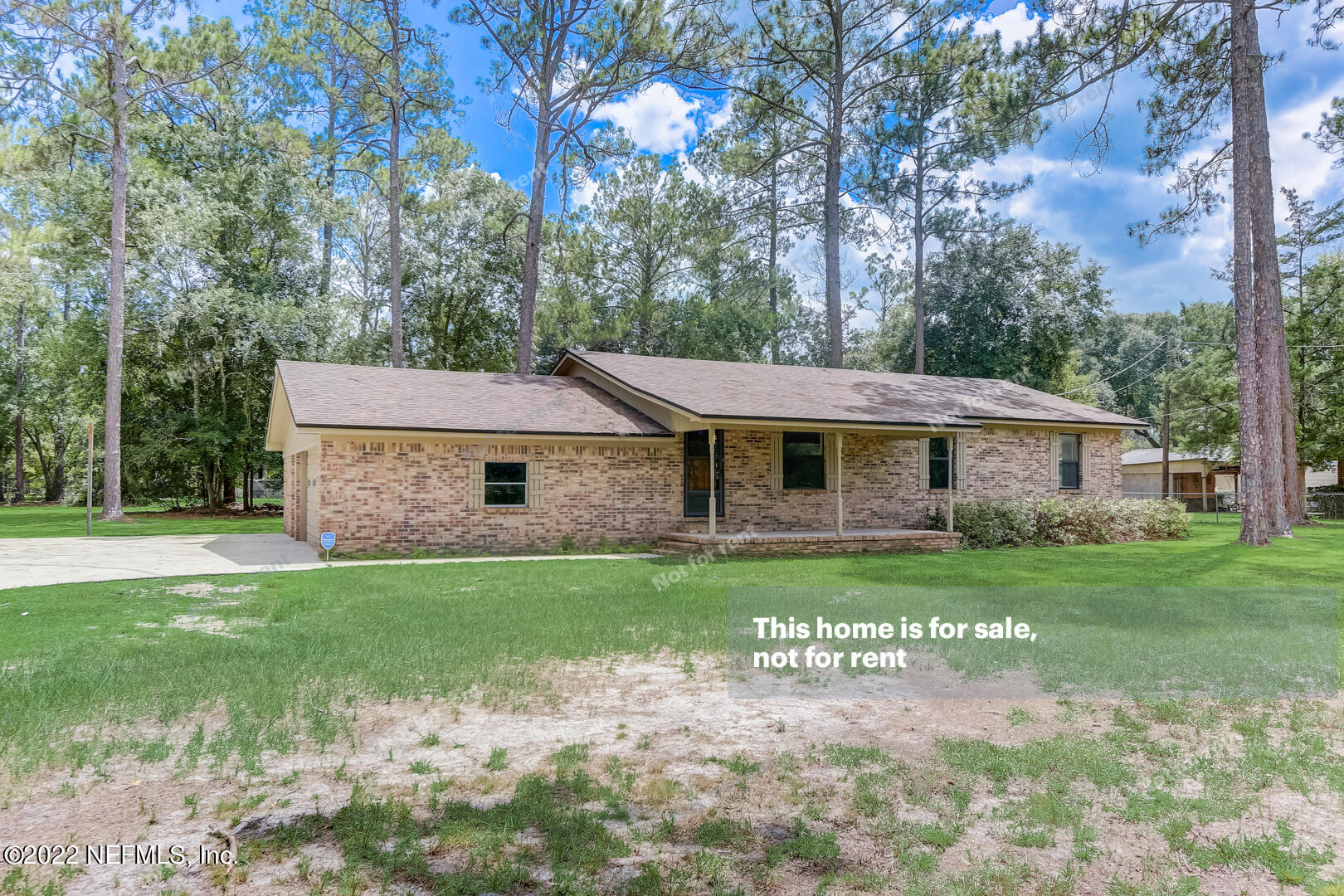 12348 Old Plank Road Jacksonville, FL 32220 - Photo 9 of 25 a front view of a house with a garden