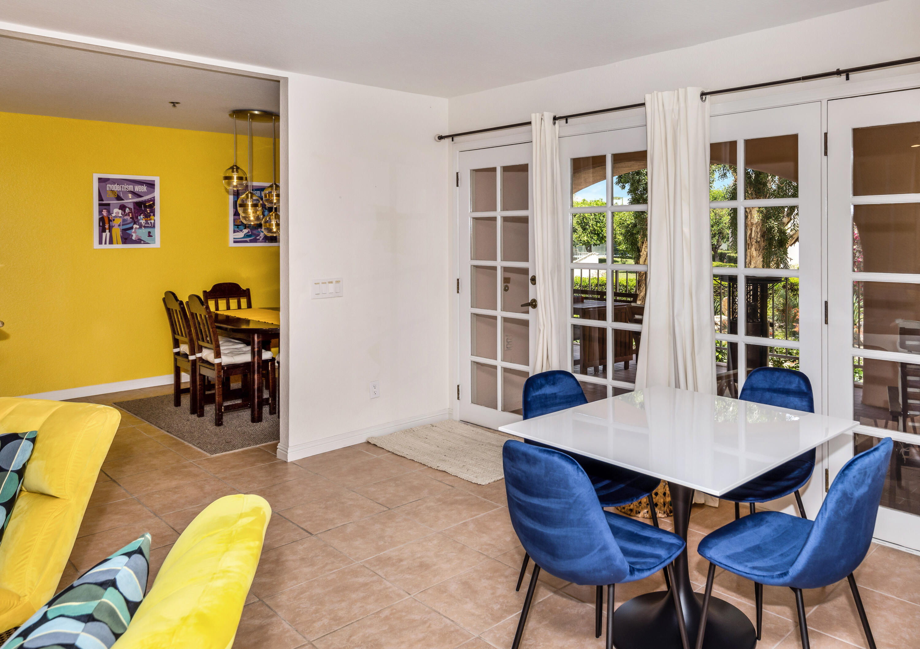 500 East Amado Road, Unit 512 Palm Springs, CA 92262 - Photo 16 of 37 a view of a dining room with furniture and wooden floor