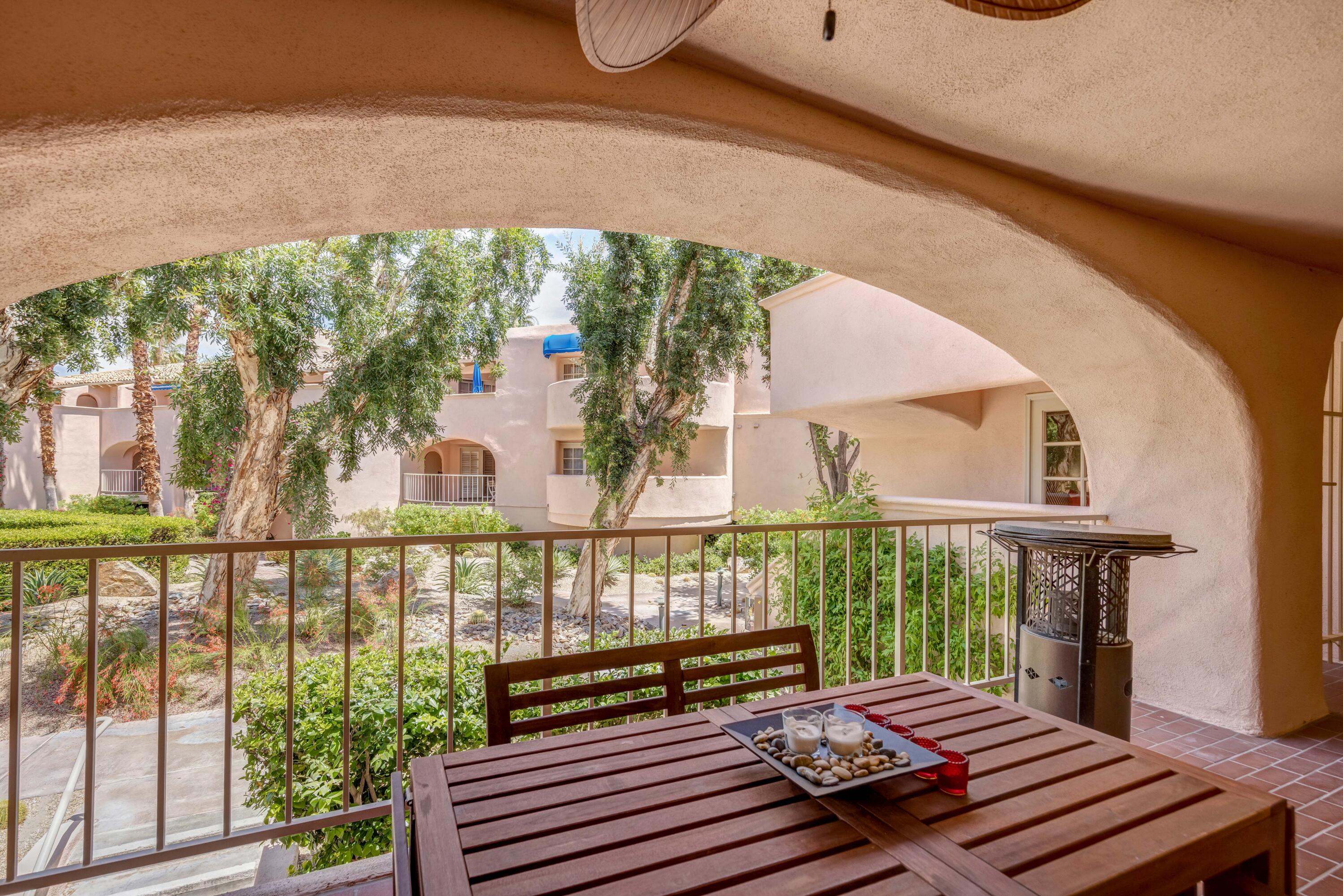 500 East Amado Road, Unit 512 Palm Springs, CA 92262 - Photo 7 of 37 a view of a chairs and table in the balcony