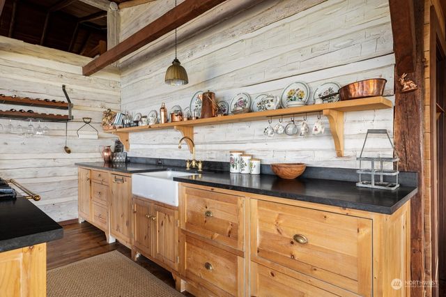 a kitchen with stainless steel appliances granite countertop a sink and cabinets