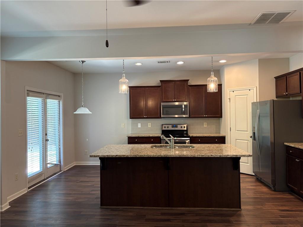 5934 Watersdown Way Flowery Branch, GA 30542 - Photo 9 of 28 a kitchen with a refrigerator and a sink
