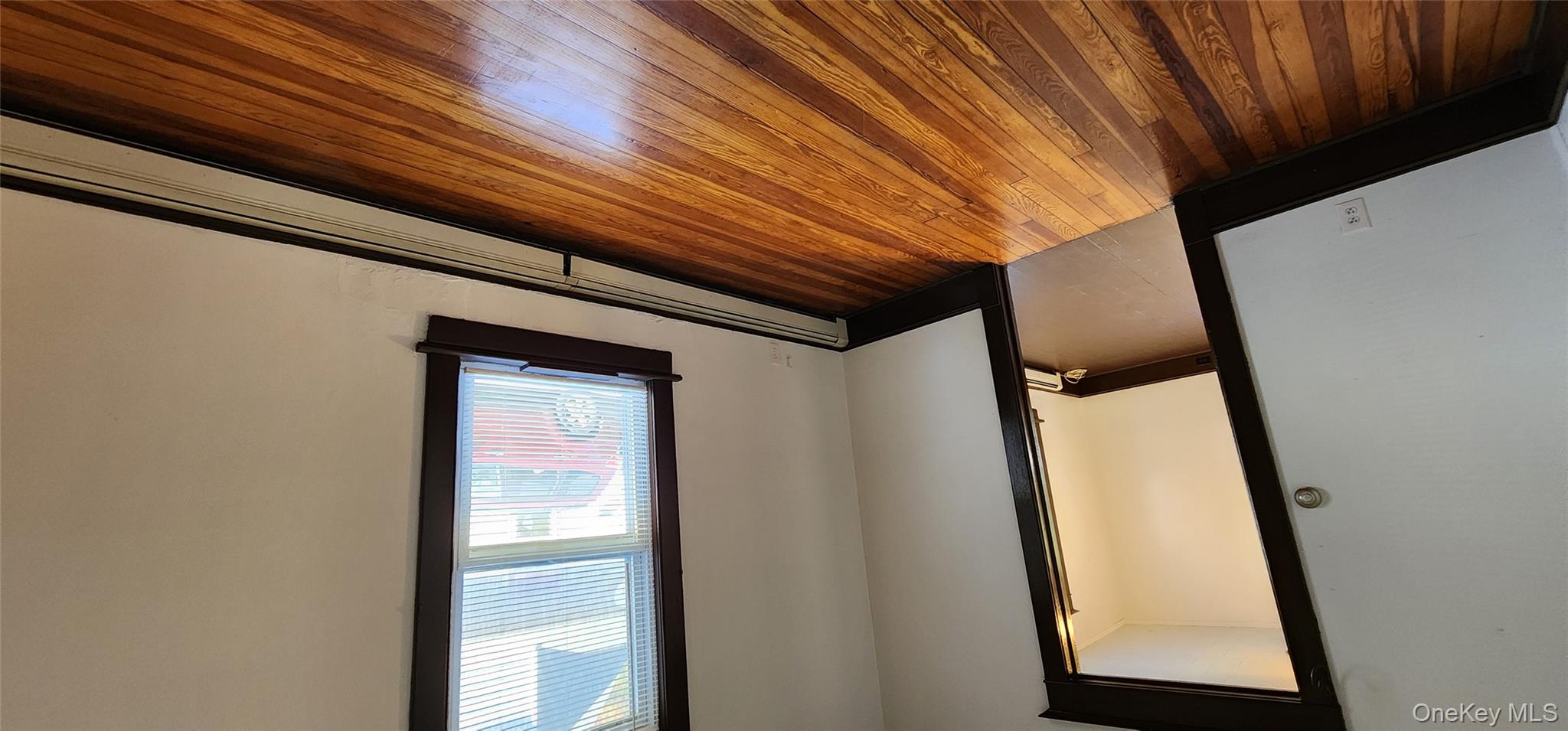 20 Delaware Street, Unit 1 Port Jervis, NY 12771 - Photo 8 of 12 Spare room with baseboard heating and dark wood-style flooring