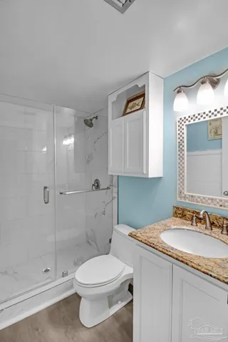 a bathroom with a sink a toilet and shower