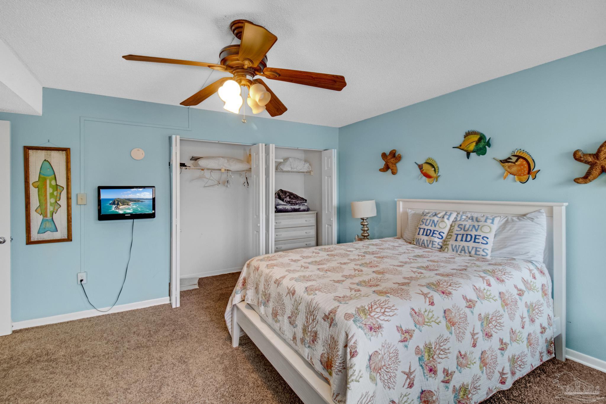 900 Fort Pickens Road, Unit 813 Pensacola Beach, FL 32561 - Photo 20 of 30 a bedroom with a bed and a chandelier