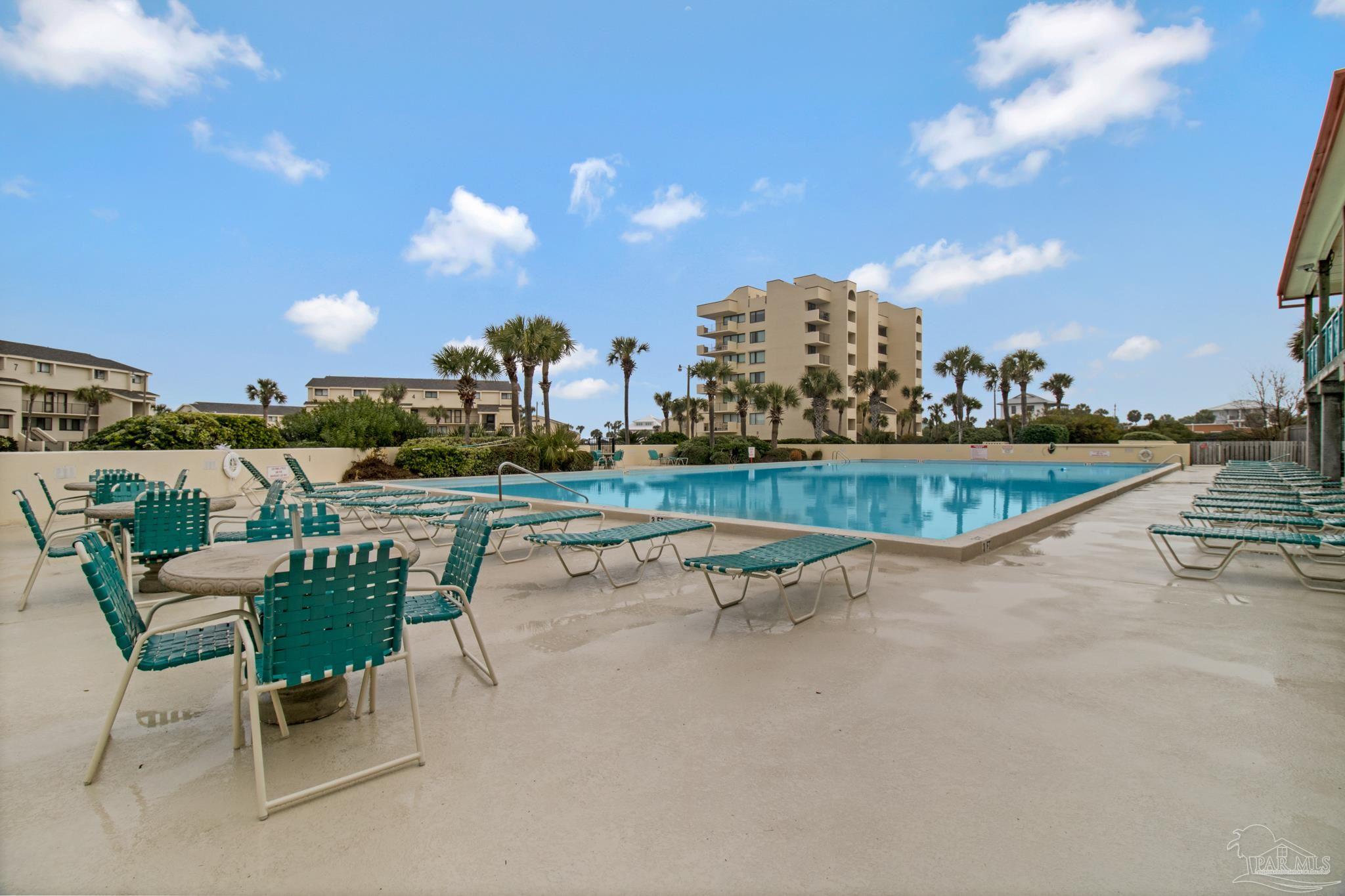 900 Fort Pickens Road, Unit 813 Pensacola Beach, FL 32561 - Photo 23 of 30 a view of a swimming pool and lounge chairs