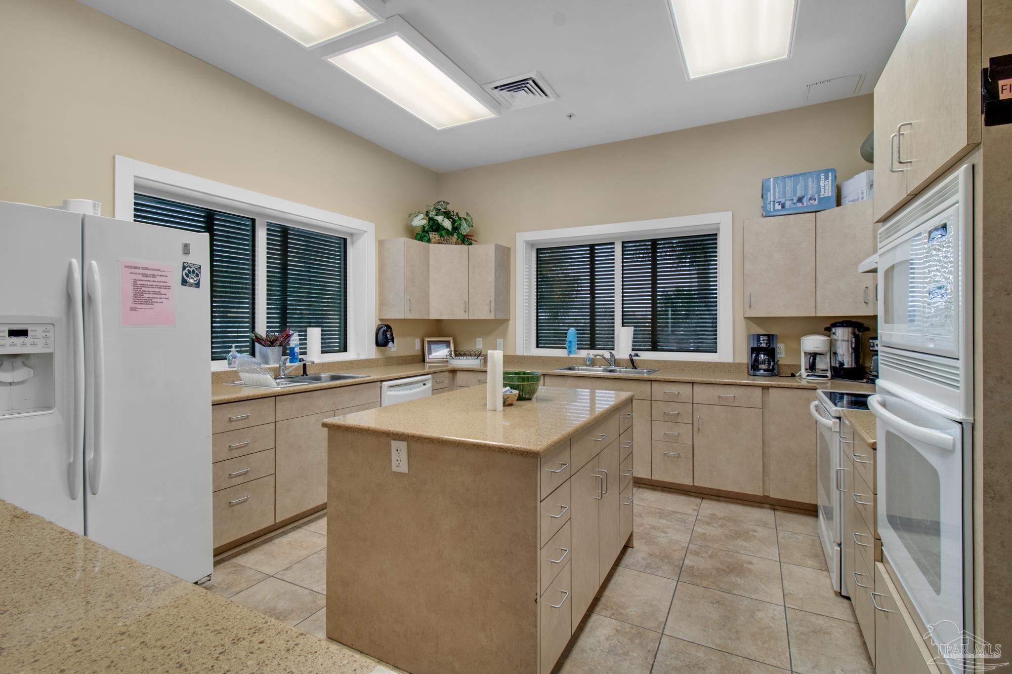 900 Fort Pickens Road, Unit 813 Pensacola Beach, FL 32561 - Photo 26 of 30 a kitchen with sink cabinets and refrigerator