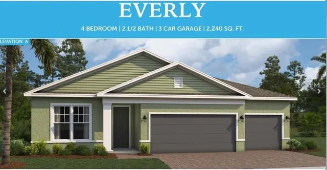 a view of a house with a garage and potted plants