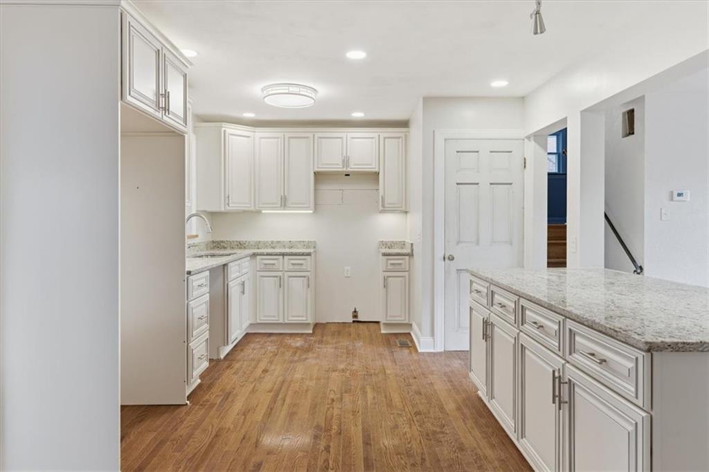 84 Hall Avenue Pittsburgh, PA 15205 - Photo 8 of 34 a kitchen with white cabinets and wooden floor