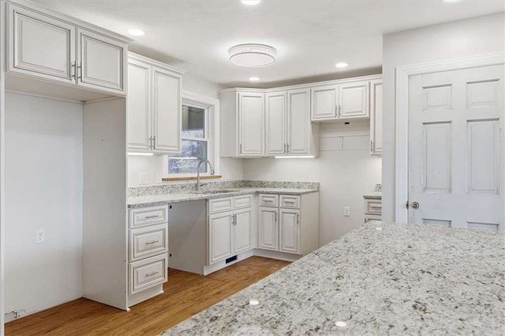 84 Hall Avenue Pittsburgh, PA 15205 - Photo 9 of 34 a kitchen with granite countertop a sink cabinets and wooden floor