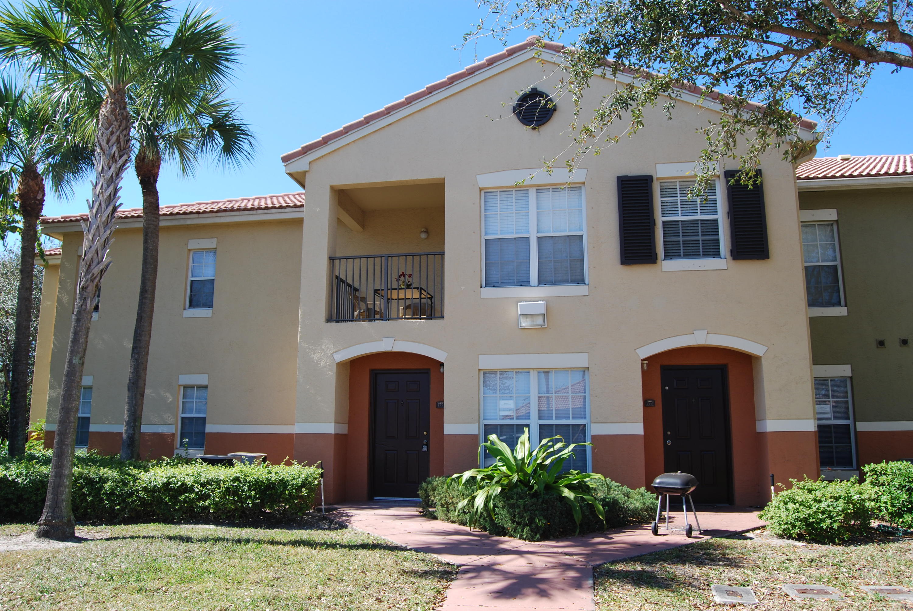 10336 Fox Trail Road South, Unit 1301 Royal Palm Beach, FL 33411 - Photo 1 of 8 a front view of a house with a yard