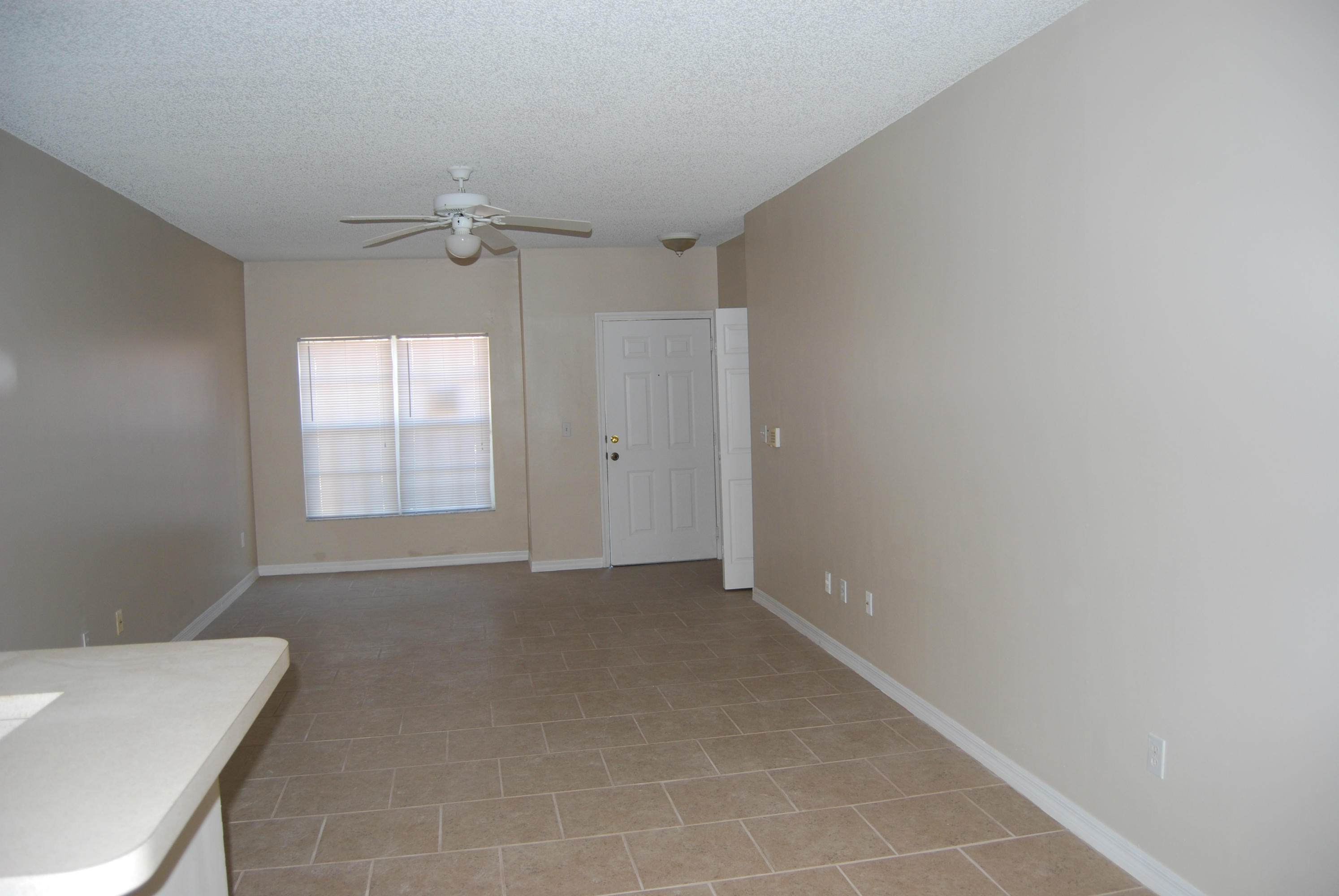 10336 Fox Trail Road South, Unit 1301 Royal Palm Beach, FL 33411 - Photo 2 of 8 a view of an empty room with a window