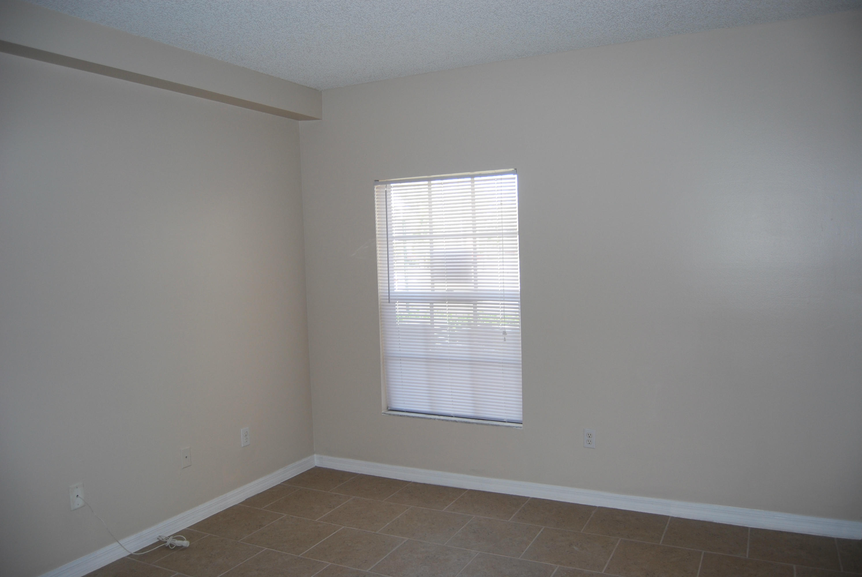 10336 Fox Trail Road South, Unit 1301 Royal Palm Beach, FL 33411 - Photo 4 of 8 an empty room with a window