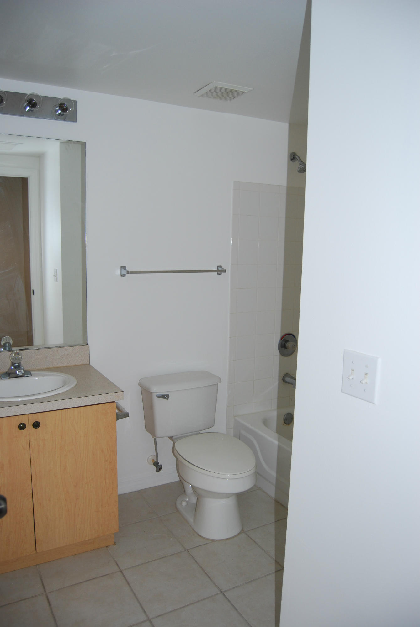 10336 Fox Trail Road South, Unit 1301 Royal Palm Beach, FL 33411 - Photo 5 of 8 a white toilet sitting next to a bathroom sink