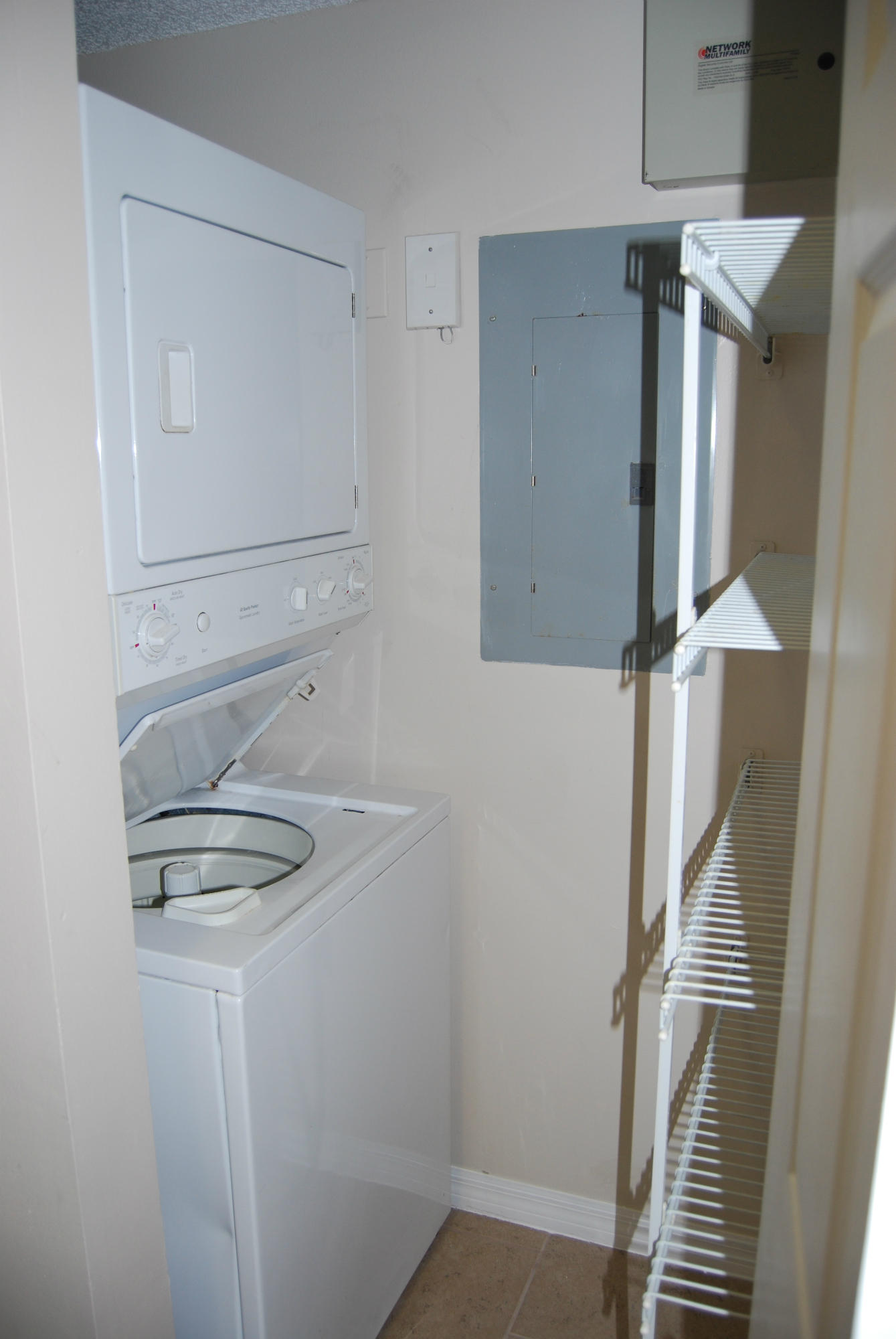 10336 Fox Trail Road South, Unit 1301 Royal Palm Beach, FL 33411 - Photo 6 of 8 a view of storage and utility room with racks on the wall