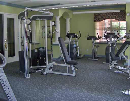 10336 Fox Trail Road South, Unit 1301 Royal Palm Beach, FL 33411 - Photo 7 of 8 a view of a room with gym equipment