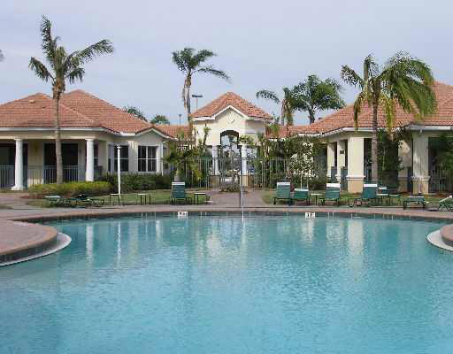 10336 Fox Trail Road South, Unit 1301 Royal Palm Beach, FL 33411 - Photo 8 of 8 a front view of a house with swimming pool having outdoor seating
