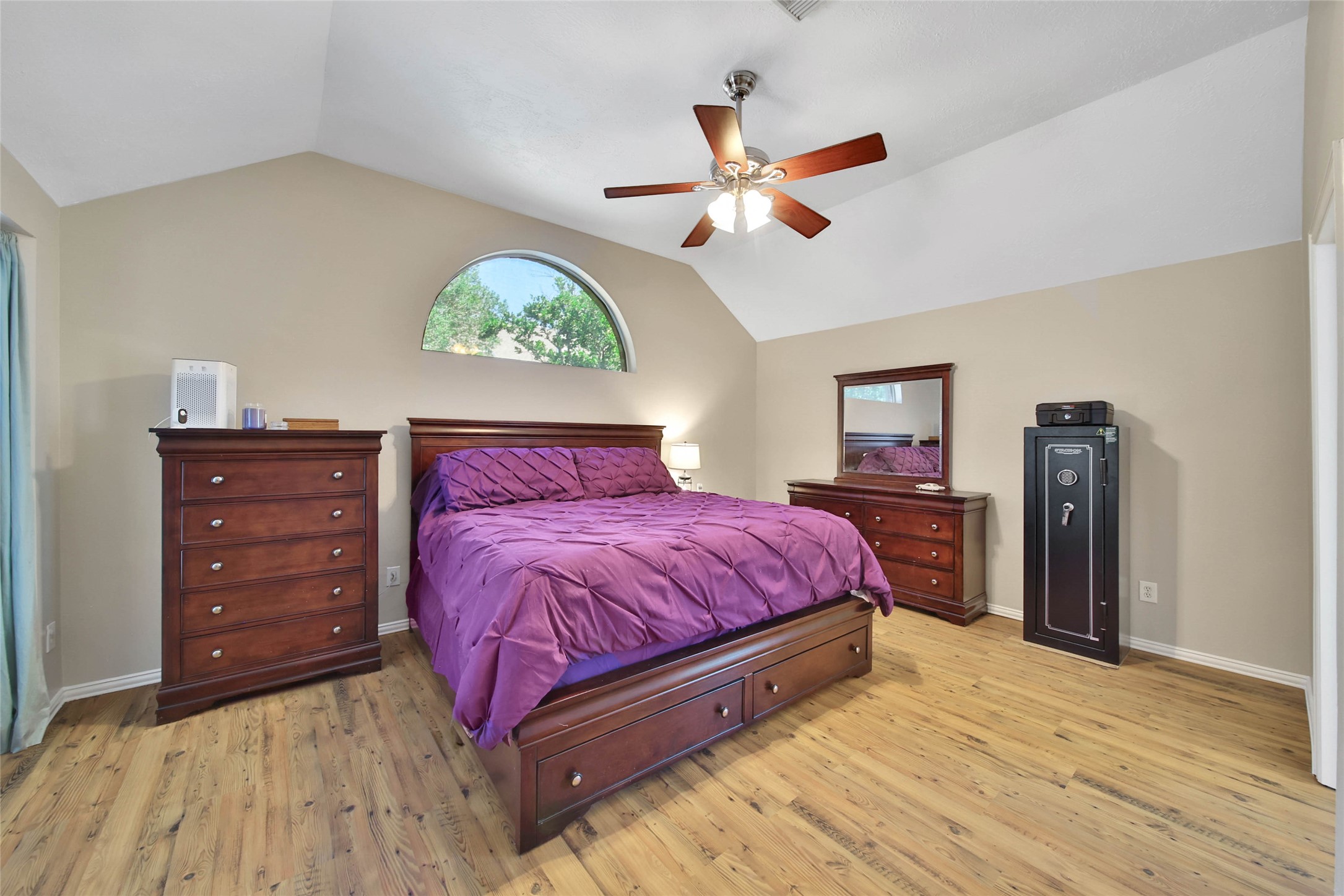 21338 Timber Pines Drive Spring, TX 77388 - Photo 19 of 29 a spacious bedroom with a bed and a chandelier