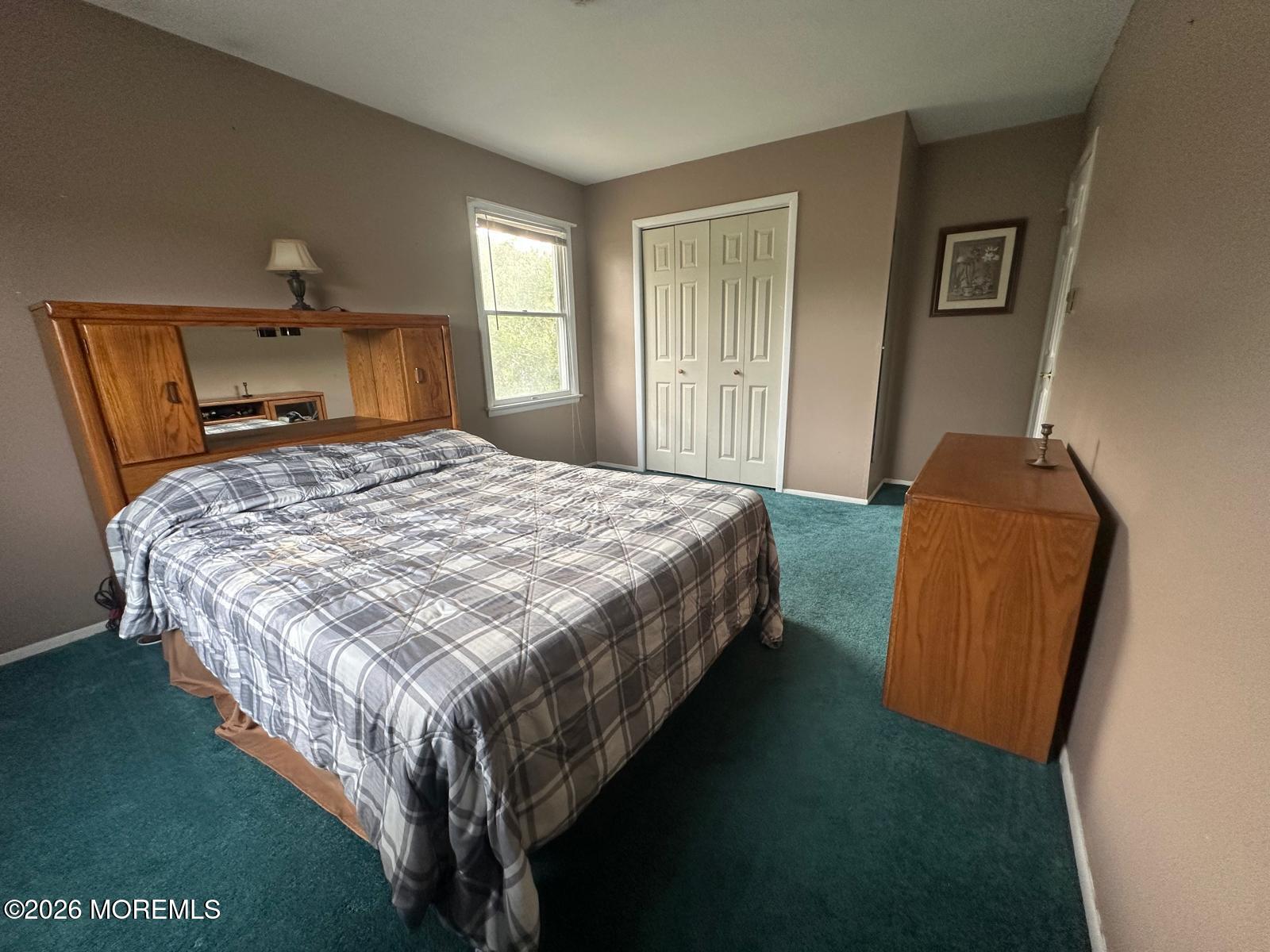 53 Sycamore Access Road Manahawkin, NJ 08050 - Photo 12 of 34 a bedroom with a bed chair and window
