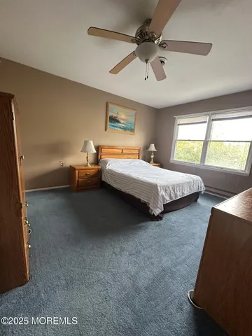 a bedroom with bed and window