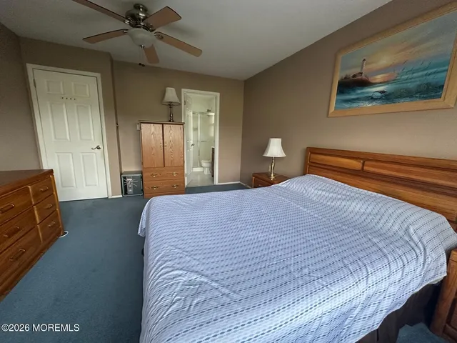 a bedroom with a bed and painting on the wall