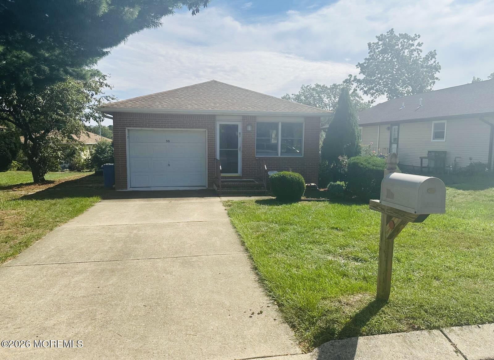 53 Sycamore Access Road Manahawkin, NJ 08050 - Photo 22 of 34 a front view of a house with garden