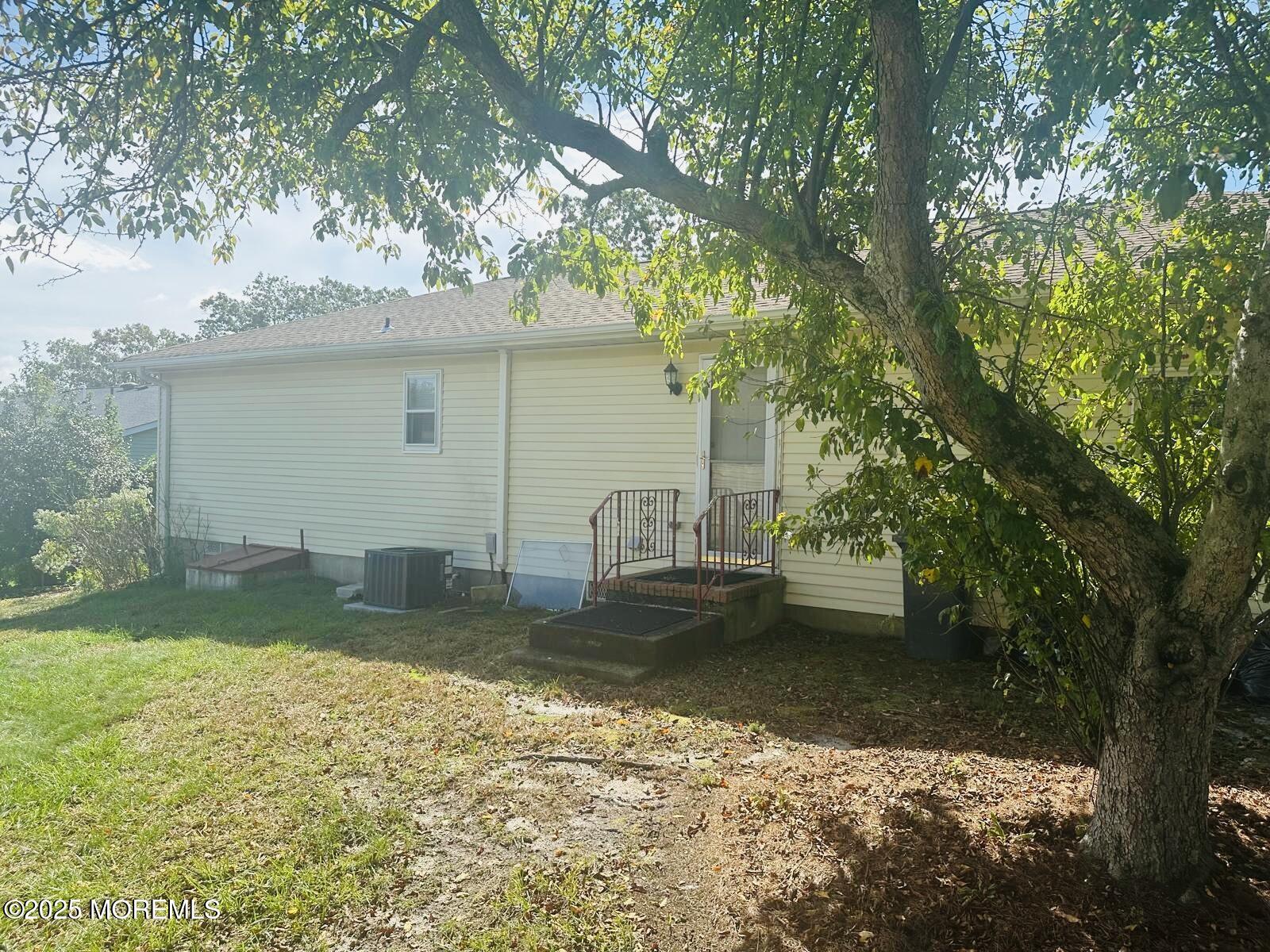 53 Sycamore Access Road Manahawkin, NJ 08050 - Photo 39 of 39 a view of a yard with a house in the background