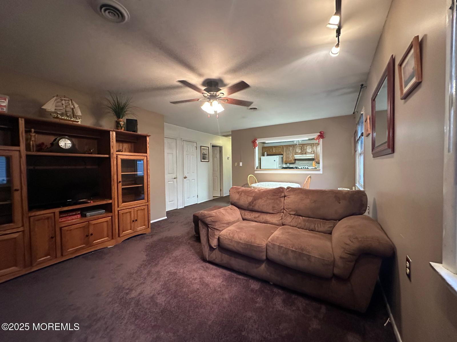 53 Sycamore Access Road Manahawkin, NJ 08050 - Photo 6 of 39 a living room with furniture and a flat screen tv