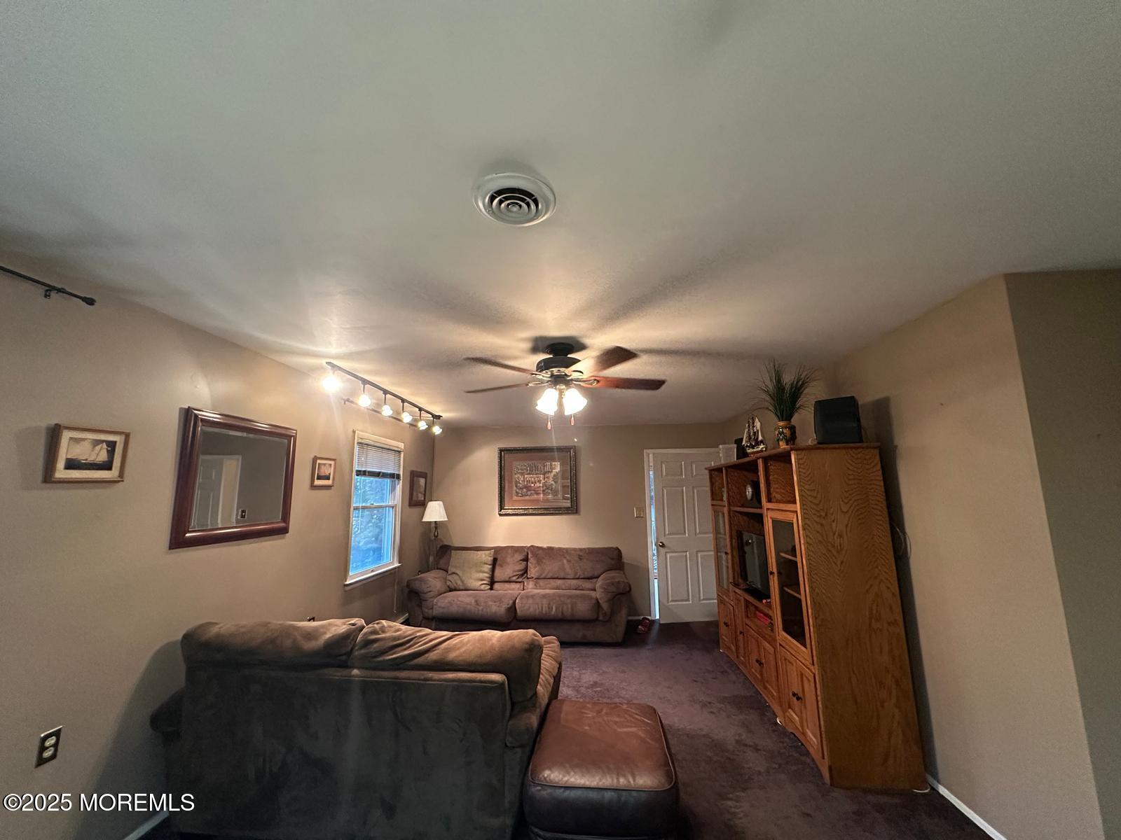 53 Sycamore Access Road Manahawkin, NJ 08050 - Photo 7 of 39 a living room with furniture and a ceiling fan