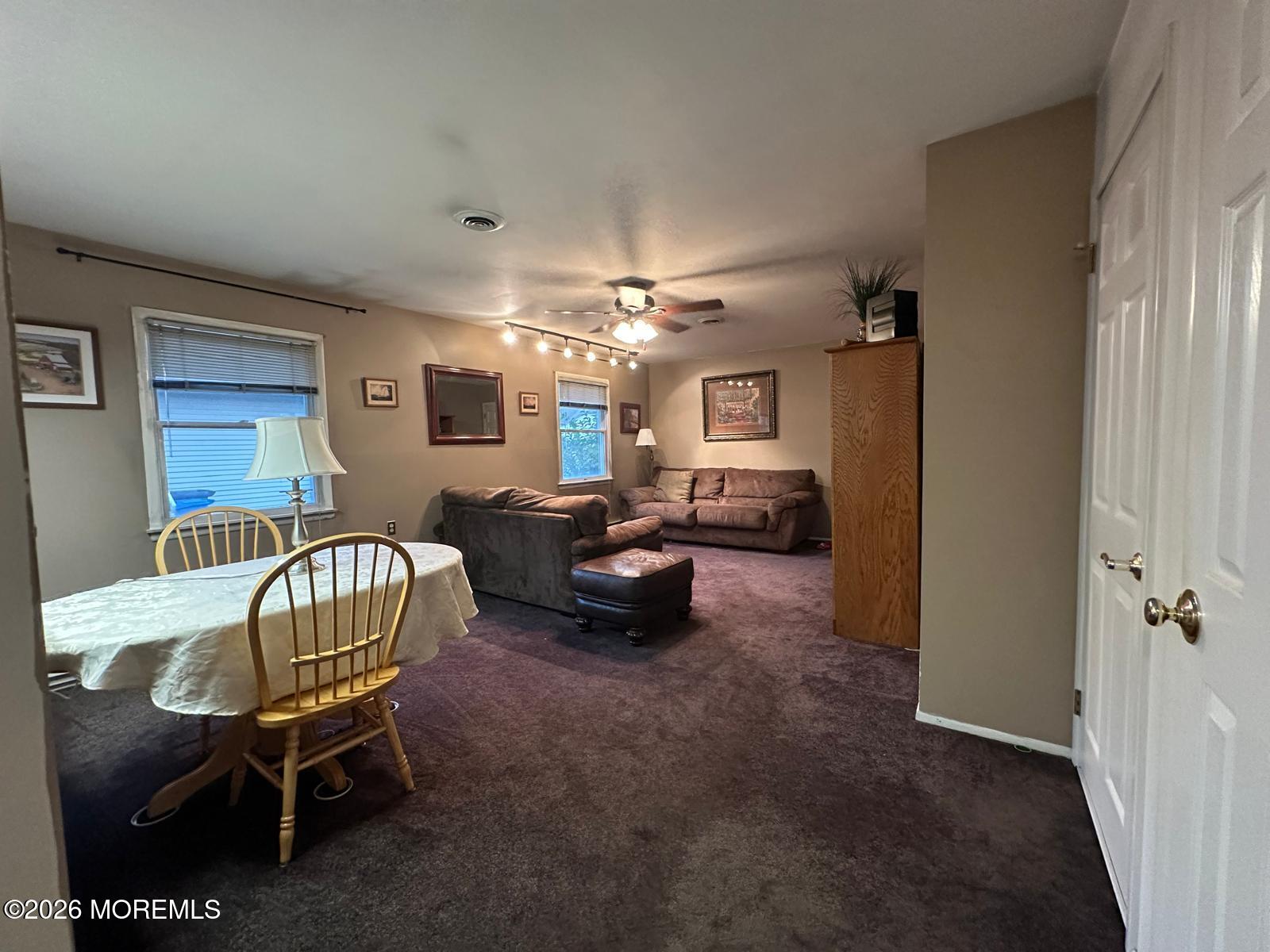 53 Sycamore Access Road Manahawkin, NJ 08050 - Photo 7 of 34 a living room with furniture and a chandelier