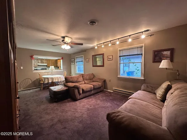 a living room with furniture chess board and a window