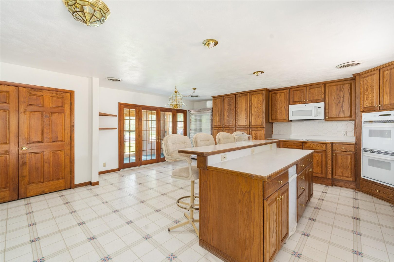 1048 Warren Street Henry, IL 61537 - Photo 13 of 34 a kitchen with stainless steel appliances granite countertop a sink and a refrigerator