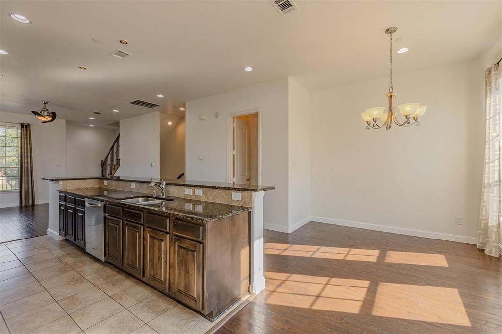 602 Arbol Irving, TX 75039 - Photo 17 of 38 a kitchen with stainless steel appliances granite countertop a stove a sink and a refrigerator