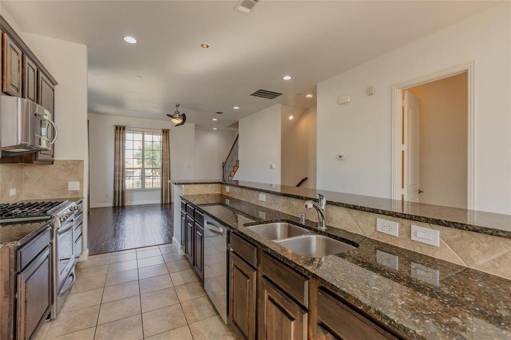 602 Arbol Irving, TX 75039 - Photo 18 of 38 a kitchen with granite countertop a sink and a stove