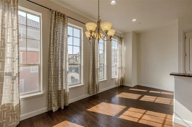 a very nice looking room with wooden floor and windows