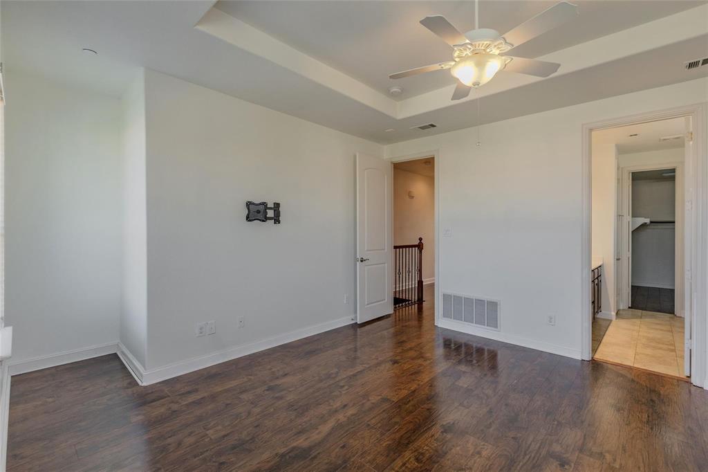 602 Arbol Irving, TX 75039 - Photo 28 of 38 an empty room with wooden floor and ceiling fan