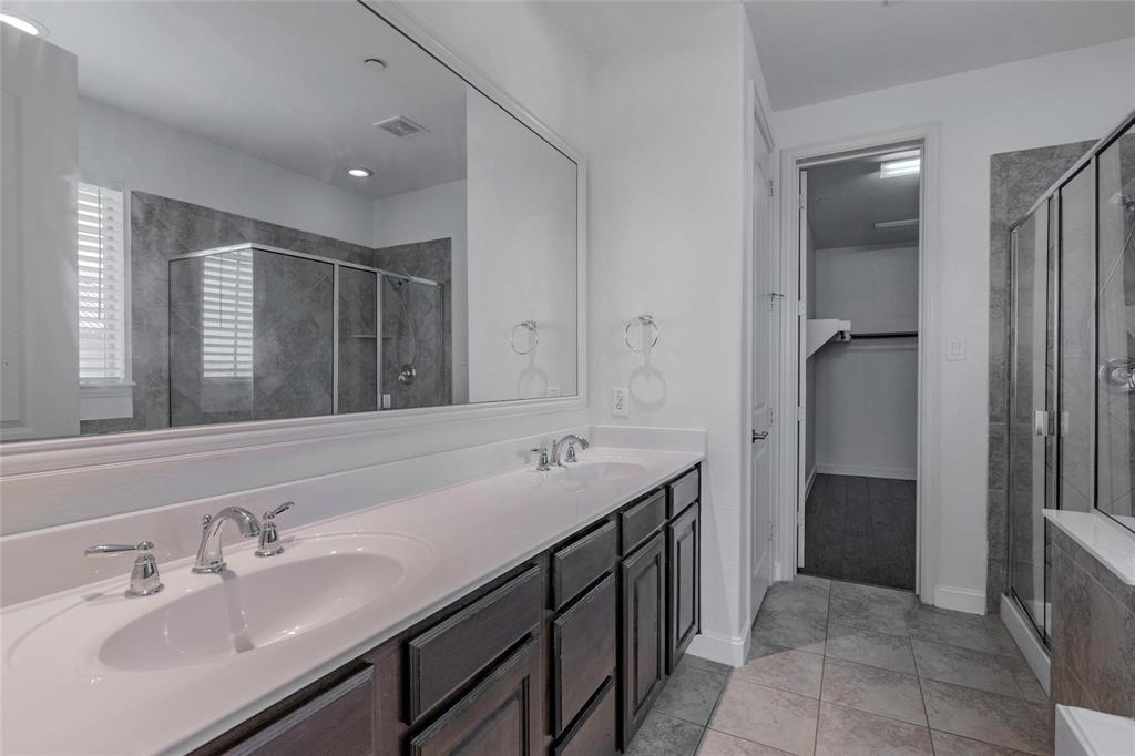 602 Arbol Irving, TX 75039 - Photo 29 of 38 a spacious bathroom with a double vanity sink and a mirror