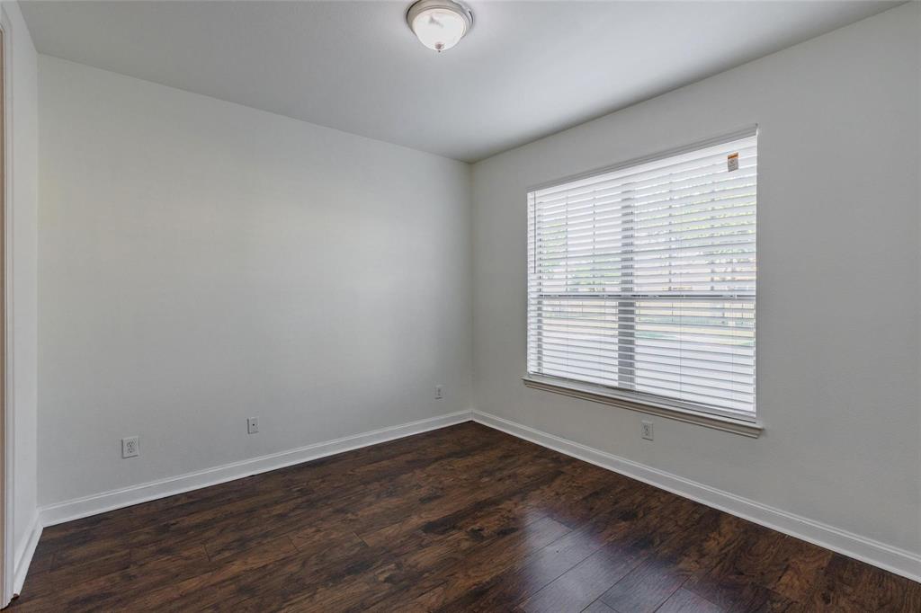 602 Arbol Irving, TX 75039 - Photo 4 of 38 an empty room with wooden floor and windows